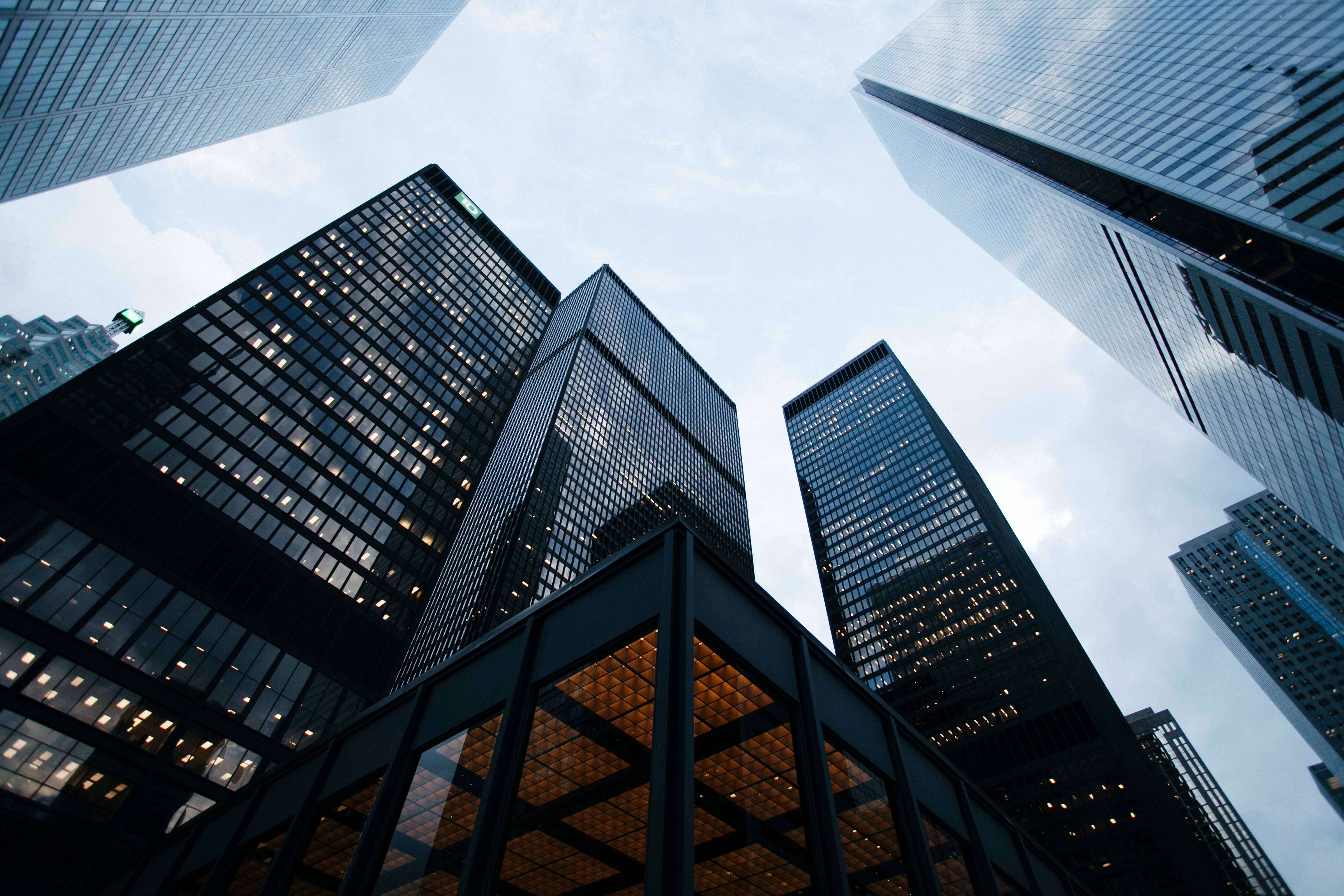 A number of modern glass skyscrapers, taken from ground level underneath