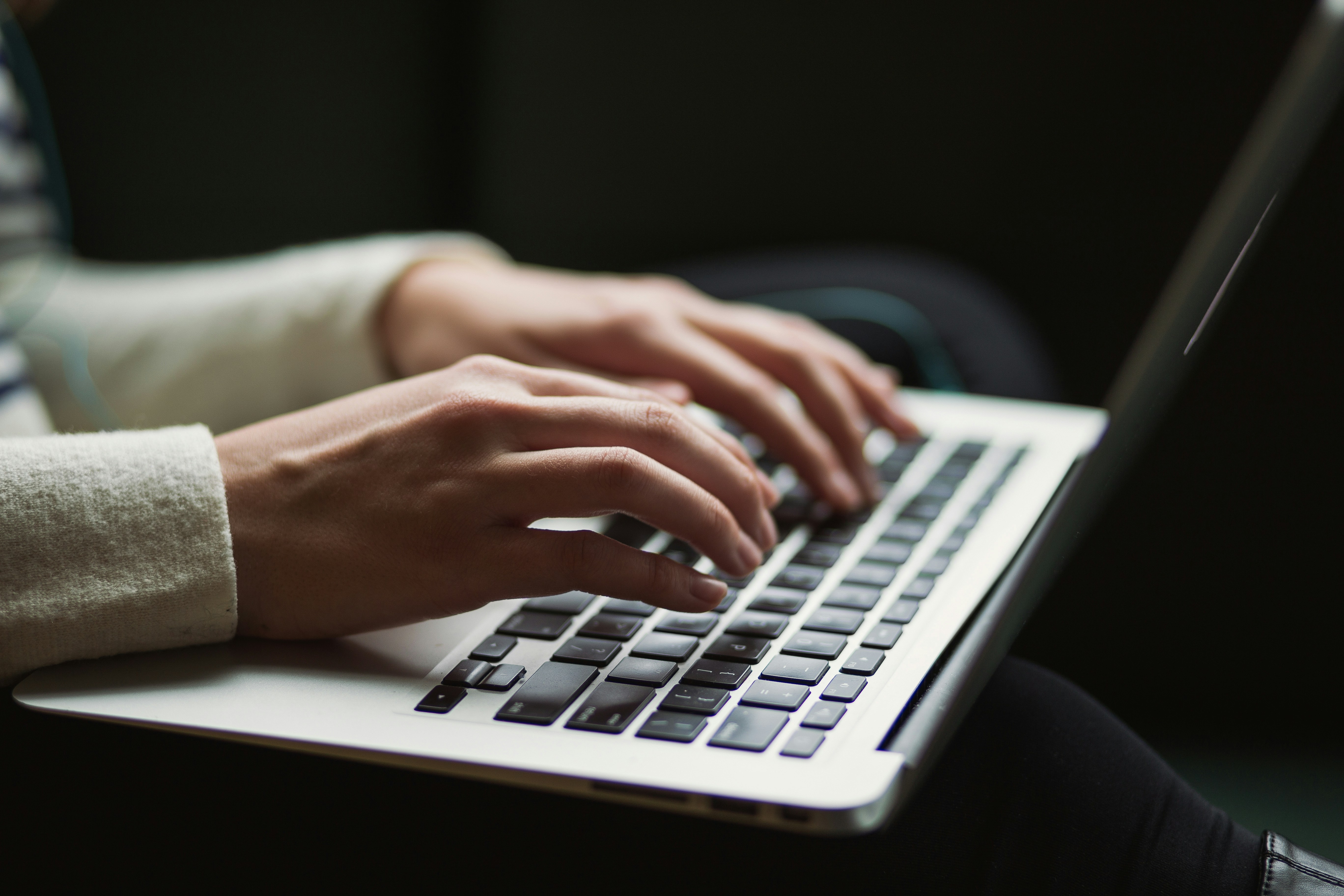 Close up on hands typing on computer