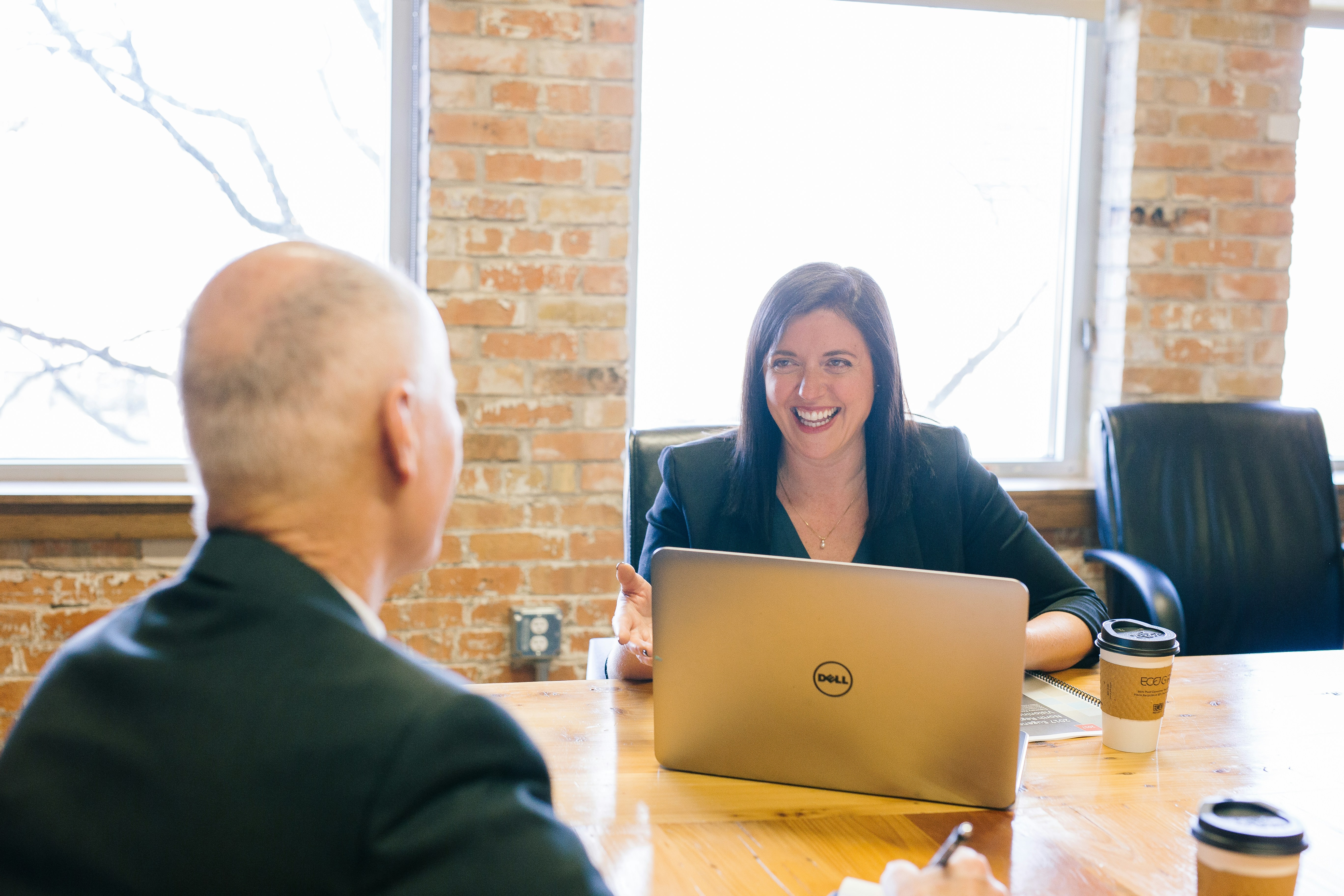 Man and woman in business dress in meeting