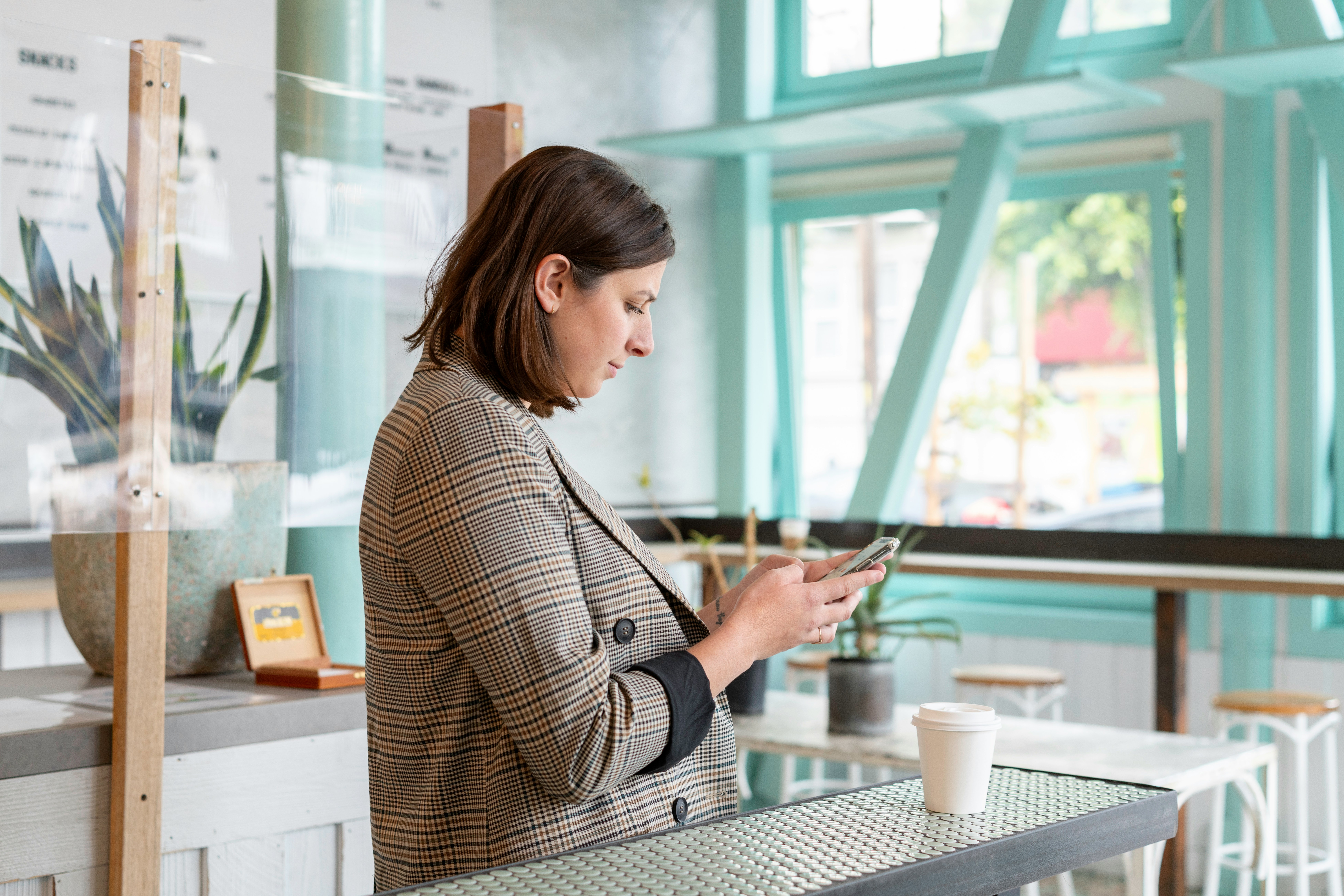 Woman looking into mobile phone and typing.