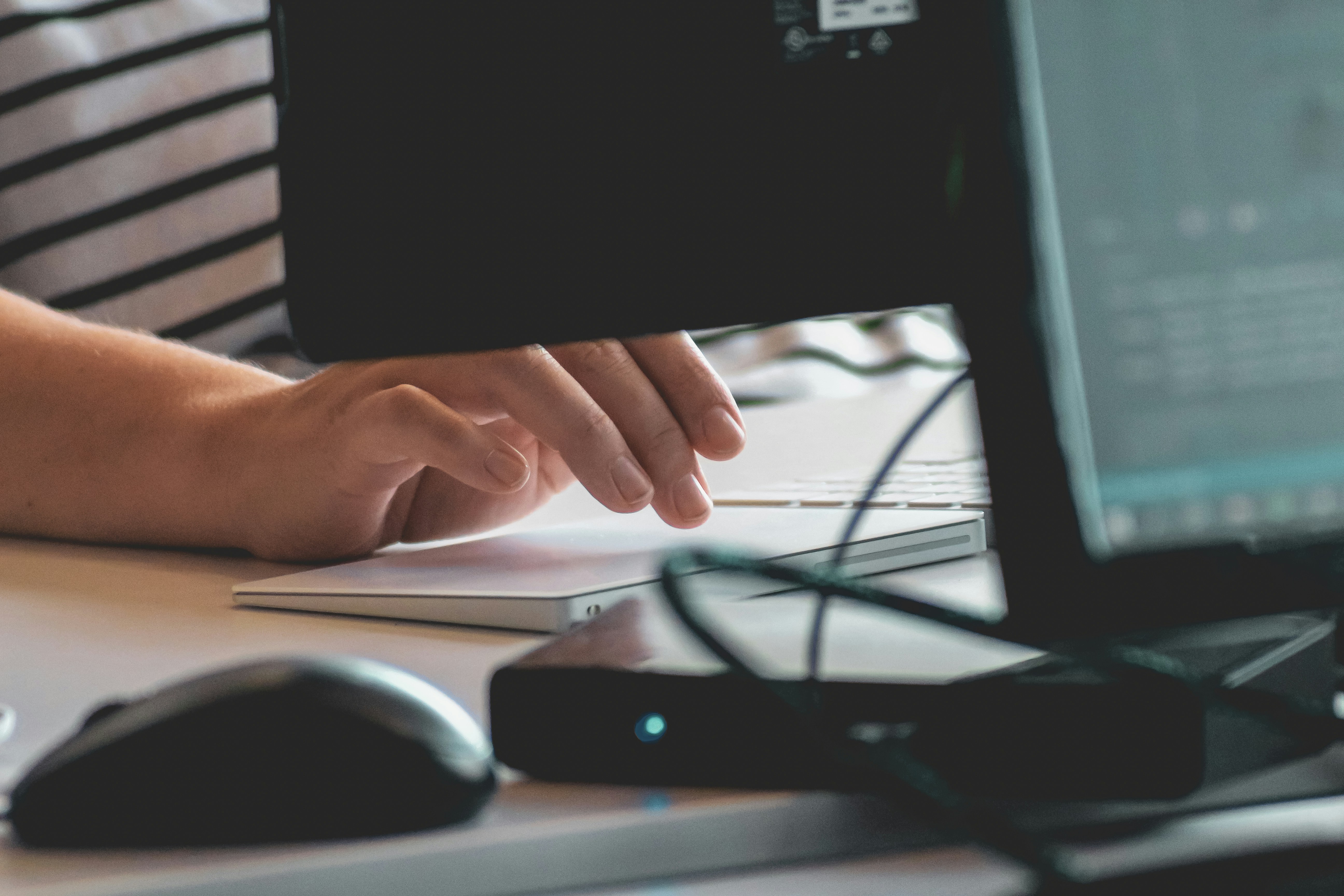 Hands typing on a computer