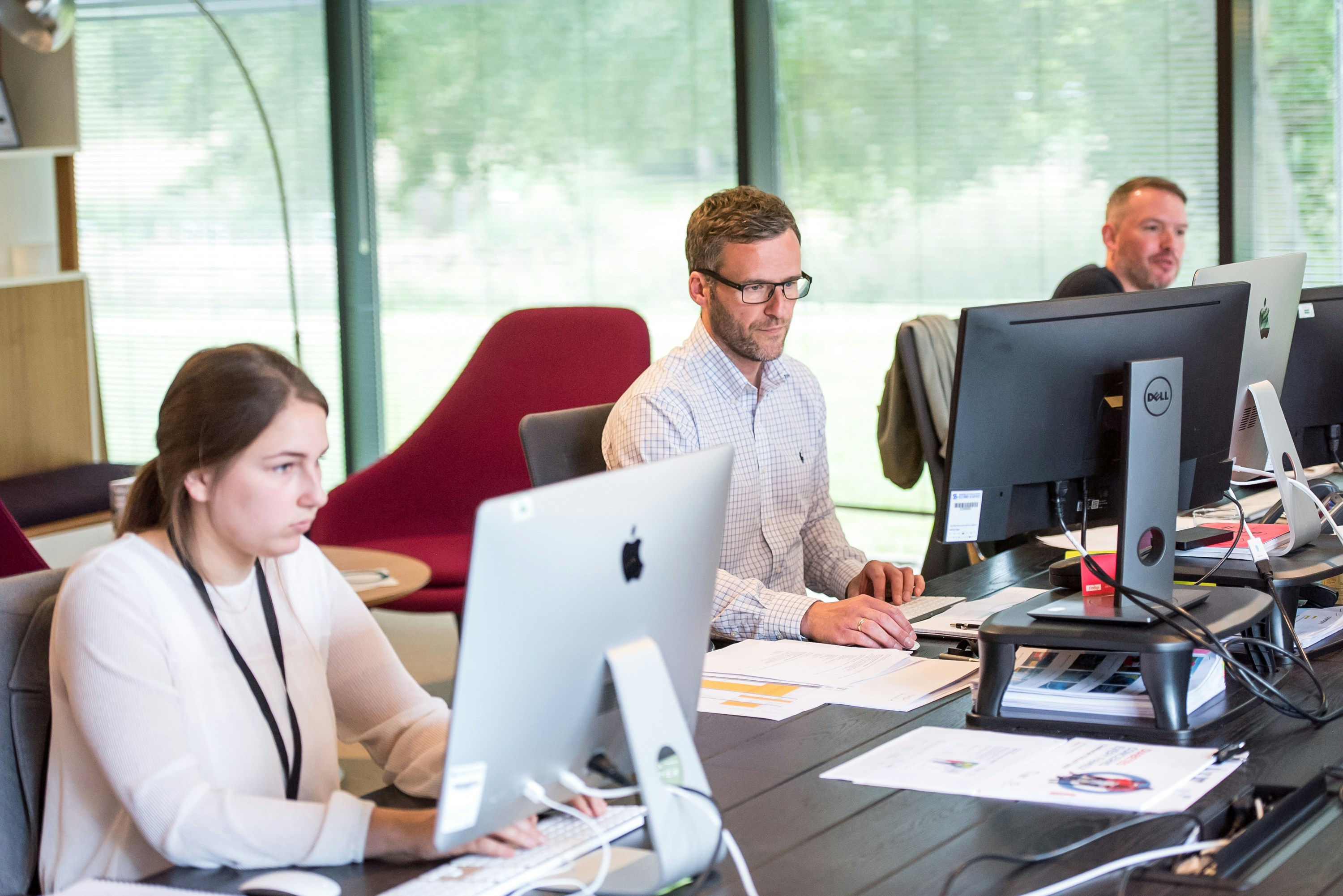 Three office workers on computers