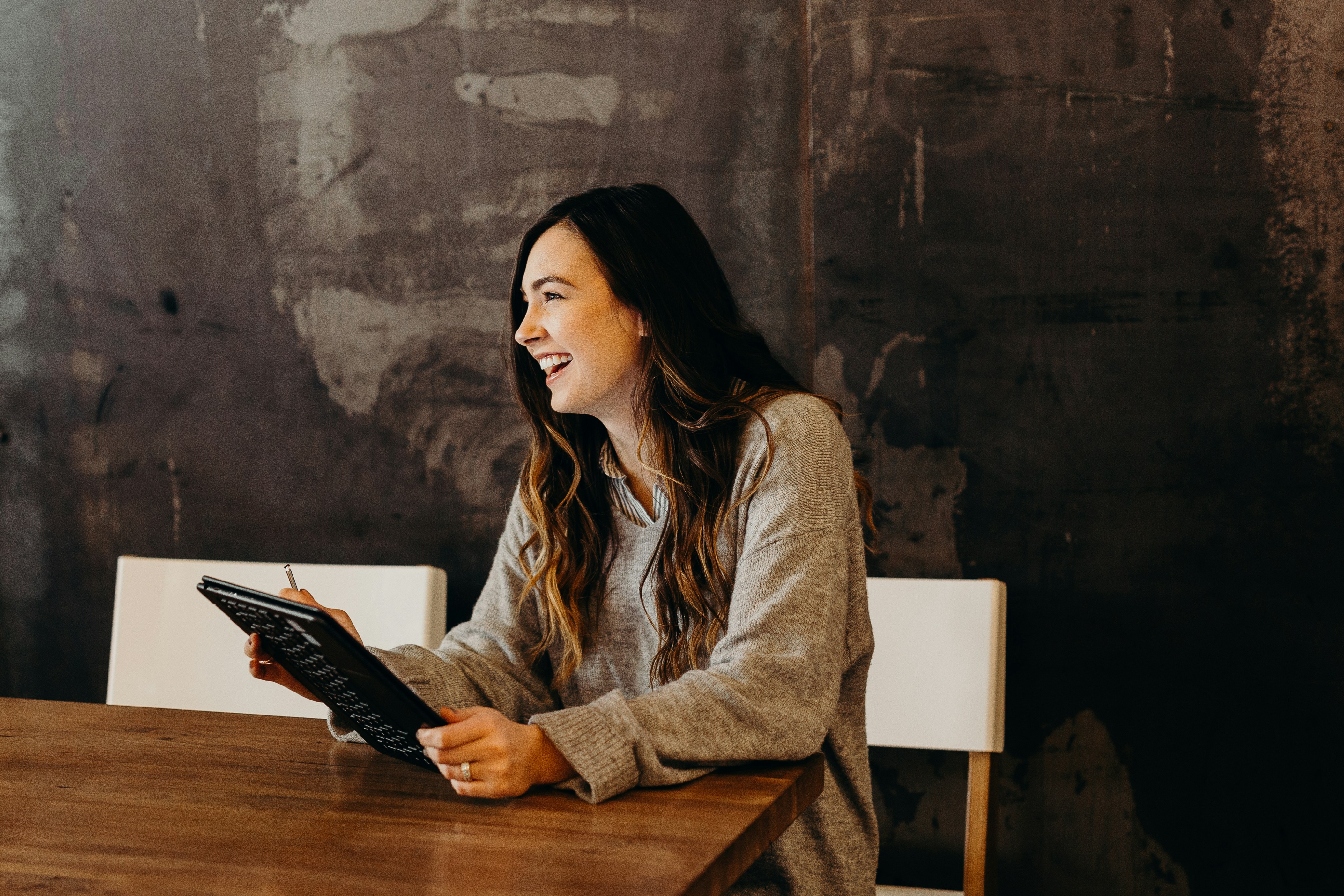 Woman using tablet and smiling